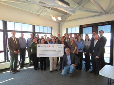 Grantees and sate and local officials surround a ceremonial check at the Port Jefferson Village Center. Holding the check are: Carole DiPaolo of the Coalition to Save Hempstead Harbor, Lynn Dwyer of the National Fish and Wildlife Foundation, and Joan Leary Matthews, Director, Clean Water Division, of the USEPA Region 2. 