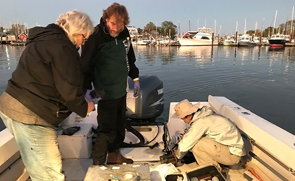 Ellen Thomas, Harold T. Stearns, a grad student, and recently retired earth and environmental professor and former scientist on the Long Island Sound Study committee Joop Varekamp collect water samples at a site. 