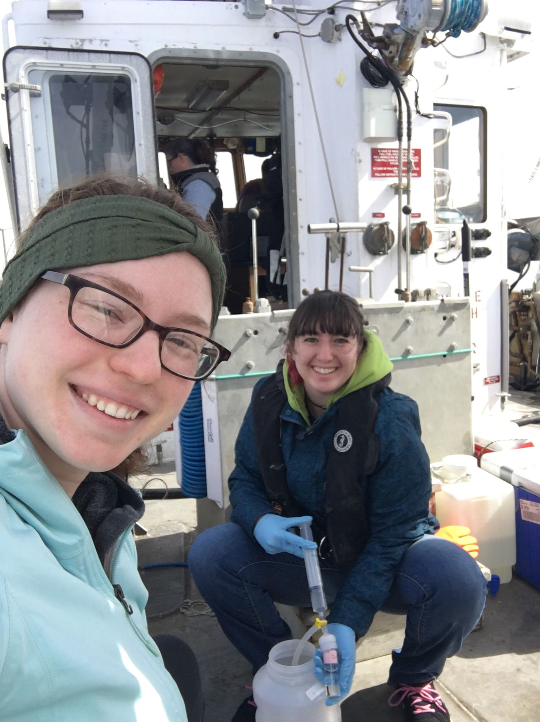 Graduate students Lauren Barrett and Allison Staniec use a tool to filter seawater for dissolved organic carbon analysis. 
