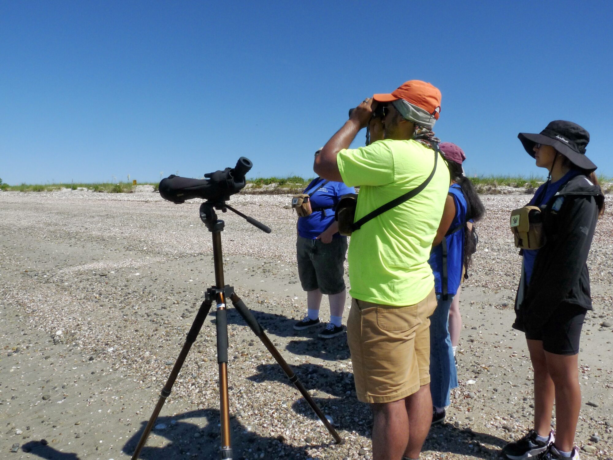 Will and the WildLife Guards use their binoculars to look for birds on Long Beach. Photo by Maya Ray.