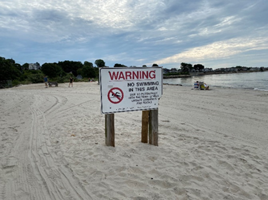 A no swim sign at a beach. 